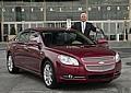 General Motors Vice Chairman Bob Lutz stands with the 2008 North American Car of the Year, the Chevrolet Malibu.